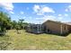 Backyard featuring pool in screened enclosure, and lush green lawn at 8317 Needles Dr, Hudson, FL 34667