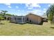 Backyard featuring pool in screened enclosure, and lush green lawn at 8317 Needles Dr, Hudson, FL 34667