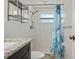 Bright bathroom featuring updated vanity, shower, and fixtures at 8317 Needles Dr, Hudson, FL 34667