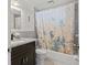Bathroom featuring granite countertop vanity and shower with themed shower curtain at 8317 Needles Dr, Hudson, FL 34667