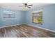 Bright bedroom features hardwood floors, window blinds and ample natural light at 8317 Needles Dr, Hudson, FL 34667