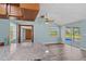 Light-filled dining area with hardwood floors, views of lanai and access to kitchen at 8317 Needles Dr, Hudson, FL 34667