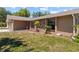 Attractive home exterior with stone accents, lush landscaping, and manicured lawn at 8317 Needles Dr, Hudson, FL 34667