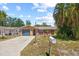 Charming single-Gathering home with a well-maintained lawn and a sunny blue sky backdrop at 8317 Needles Dr, Hudson, FL 34667