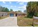 Charming single-Gathering home with a well-maintained lawn and a sunny blue sky backdrop at 8317 Needles Dr, Hudson, FL 34667