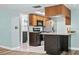 Bright kitchen features stainless steel appliances, granite counters and an island with bar seating at 8317 Needles Dr, Hudson, FL 34667