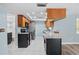 Modern kitchen boasts stainless steel appliances, granite countertops and dark cabinetry at 8317 Needles Dr, Hudson, FL 34667