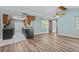 Open-concept living room has hardwood floors and easy access to kitchen at 8317 Needles Dr, Hudson, FL 34667