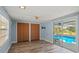 Bright living room with wood floors, backyard access, and pool view at 8317 Needles Dr, Hudson, FL 34667