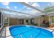 Inviting backyard pool area with a screened enclosure and ample patio space at 8317 Needles Dr, Hudson, FL 34667