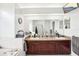 Bathroom featuring a dual vanity with modern countertops, tub and a big mirror at 8804 Poe Dr, Hudson, FL 34667