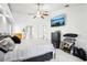 Bright and spacious bedroom with white walls, carpet, ceiling fan and television at 8804 Poe Dr, Hudson, FL 34667