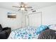 Bright bedroom featuring a starfish themed bedspread, mounted TV and double closets for storage at 8804 Poe Dr, Hudson, FL 34667
