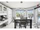 Bright dining area with modern lighting, large windows, and easy access to outdoor pool area at 8804 Poe Dr, Hudson, FL 34667