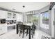 Charming dining area features a modern chandelier and a large window with a view at 8804 Poe Dr, Hudson, FL 34667