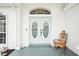 Close-up of a charming front door with a rocking chair and decorative accents, adding character to the entrance at 8804 Poe Dr, Hudson, FL 34667