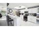 Kitchen features a breakfast bar, stainless steel appliances, recessed lighting, and white cabinetry at 8804 Poe Dr, Hudson, FL 34667