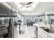 Modern kitchen with stainless steel appliances, sky light, white cabinets, and a breakfast bar at 8804 Poe Dr, Hudson, FL 34667