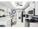Well-lit kitchen features stainless steel appliances, white cabinets and modern finishes at 8804 Poe Dr, Hudson, FL 34667