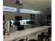 Spacious kitchen with modern appliances and breakfast bar, with a partial view of dining area at 8804 Poe Dr, Hudson, FL 34667