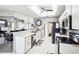 Well-lit white kitchen features modern appliances, sleek countertops, and an open design for easy entertaining at 8804 Poe Dr, Hudson, FL 34667