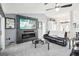 Modern living room featuring a slate tile accent wall with a TV and electric fireplace at 8804 Poe Dr, Hudson, FL 34667