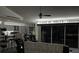 Cozy open-concept living area with an illuminated decor sign, kitchen and a fireplace at 8804 Poe Dr, Hudson, FL 34667