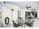 Relaxing patio area featuring outdoor shower, ceiling fans, outdoor dining table, and lounge seating at 8804 Poe Dr, Hudson, FL 34667