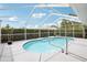 This screened-in pool area features a bright pool with a seating area surrounding it at 8804 Poe Dr, Hudson, FL 34667