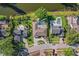 Stunning aerial view of home with backyard pool, lush landscaping, and waterfront views at 9072 Baywood Park Dr, Seminole, FL 33777
