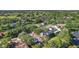 Peaceful aerial view of beautiful homes surrounded by a lake and lush landscaping at 9072 Baywood Park Dr, Seminole, FL 33777