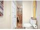 Bright bathroom featuring a tiled shower, toilet, and surfboard wall art at 9072 Baywood Park Dr, Seminole, FL 33777
