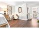 View of a corner in the bedroom area, featuring a chair, decorative pictures, and hardwood flooring at 9072 Baywood Park Dr, Seminole, FL 33777