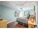 Charming bedroom with a coastal design, ceiling fan, and wood floors, offering a relaxing retreat at 9072 Baywood Park Dr, Seminole, FL 33777