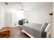 Neutral bedroom features a bed, workspace, and closet with hardwood floors at 9072 Baywood Park Dr, Seminole, FL 33777