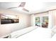 Bright bedroom featuring a ceiling fan, and sliding glass doors to the outdoor pool area and lounge at 9072 Baywood Park Dr, Seminole, FL 33777