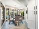 Inviting dining area with wicker chairs, backyard views, and natural light at 9072 Baywood Park Dr, Seminole, FL 33777