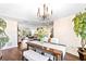 Dining room featuring wood floors, stylish seating, a decorative chandelier, and lots of natural light at 9072 Baywood Park Dr, Seminole, FL 33777