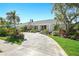 Well-maintained home with landscaped front yard, a circular driveway, and mature trees for added curb appeal at 9072 Baywood Park Dr, Seminole, FL 33777