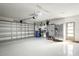 Spacious garage with epoxy flooring and ample storage space with shelving and metal storage cabinets at 9072 Baywood Park Dr, Seminole, FL 33777