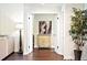 Hallway view featuring hardwood floors, neutral paint, and decorative furniture at 9072 Baywood Park Dr, Seminole, FL 33777