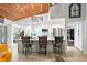 Spacious kitchen bar area with white cabinets, granite countertops, and modern lighting at 9072 Baywood Park Dr, Seminole, FL 33777
