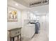 Laundry room featuring storage, utility sink, front loading washer and dryer, and decor at 9072 Baywood Park Dr, Seminole, FL 33777