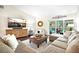 Comfortable living room featuring a sectional sofa, and sliding doors leading to the lanai at 9072 Baywood Park Dr, Seminole, FL 33777