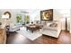 Cozy living room with plush seating, wood floors, sliding glass doors, and views of the pool area at 9072 Baywood Park Dr, Seminole, FL 33777