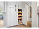 Organized pantry featuring pull-out shelves inside white cabinetry for easy access at 9072 Baywood Park Dr, Seminole, FL 33777