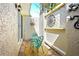 Outdoor patio with metal seating, greenery, yellow mat, stone flooring, and a white fence at 9072 Baywood Park Dr, Seminole, FL 33777