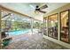 Screened-in pool with a covered lanai, ceiling fan, outdoor seating and a view of the backyard at 9072 Baywood Park Dr, Seminole, FL 33777