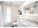 Elegant powder room featuring a marble countertop, modern fixtures, and decorative accents at 9072 Baywood Park Dr, Seminole, FL 33777