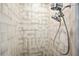 Close up of shower with modern tile, dual shower heads, and gray grout at 9072 Baywood Park Dr, Seminole, FL 33777